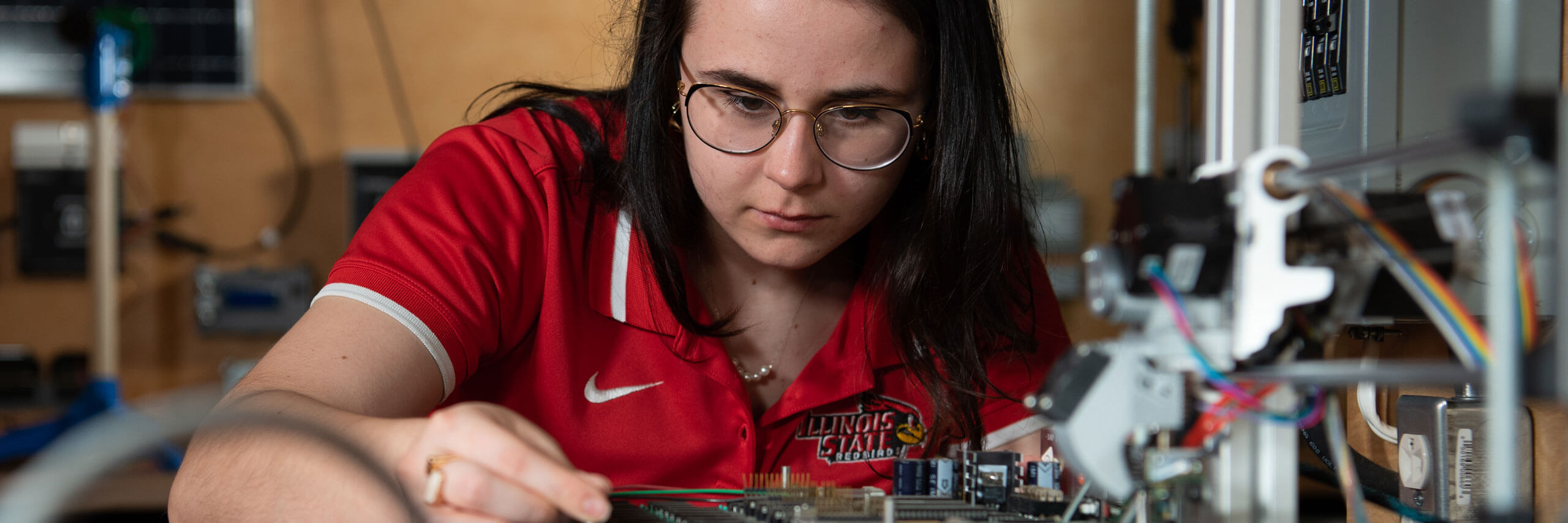 Student works on a circuit board.